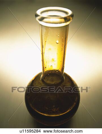 Brown-colored Oil in a Round Flask, Drops Visual, High Angle View View Large Photo Image Picture - Brown-colored Oil in a Round Flask, Drops Visual, High Angle View. Fotosearch