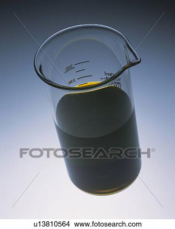 Picture - Dark-brown Oil in a Measuring Cup, High Angle View. Fotosearch
