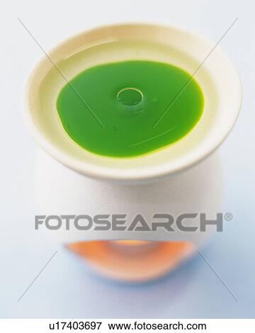 Green-colored Aroma Oil Being Warmed Up, High Angle View, Differential Focus View Large Photo Image Stock Photo - Green-colored Aroma Oil Being Warmed Up, High Angle View, Differential Focus. Fotosearch