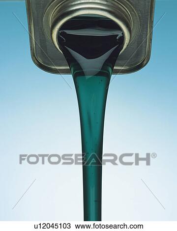 Stock Image - Green-colored Oil Flowing Out of a Silvern Can, Front View. Fotosearch