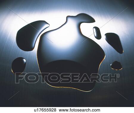 Stock Photo - Grey Oil On a Silvern Surface, High Angle View. Fotosearch