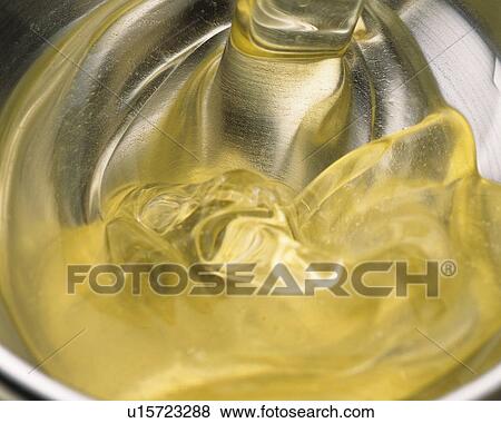 Light Yellow-colored Liquid Being Poured, High Angle View View Large Photo Image Stock Photo - Light Yellow-colored Liquid Being Poured, High Angle View. Fotosearch