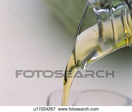 Stock Photo - Light Yellow Oil Being Poured Into Another Flask, High Angle View, Differential Focus. Fotosearch