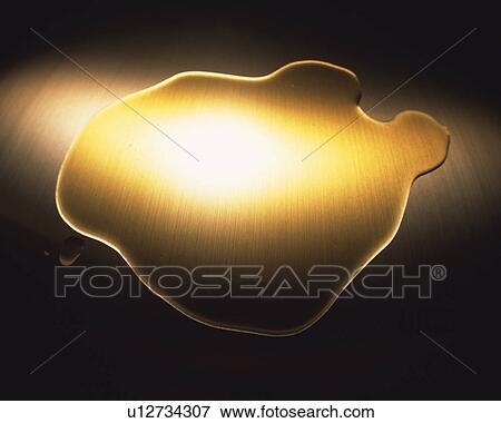 Stock Photo - Light-yellow Oil on a Wooden Floor, Partly Shined On By a Light, High Angle View. Fotosearch