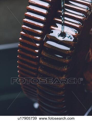 Stock Photo - Oil Being Dipped On Two Rusty Gears, Differential Focus, High Angle View. Fotosearch