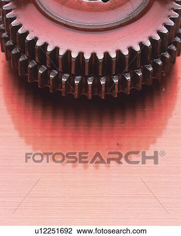 Stock Image -  One Gears, Covered in Pink-colored Oil, High Angle View, Copy Space. Fotosearch