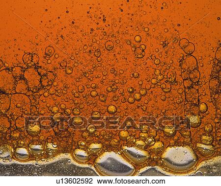 Stock Image - Orange-colored Oil, Containing a Lot of Bubbles. Fotosearch