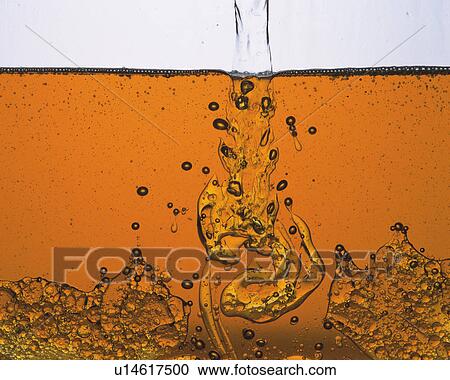 Stock Image - Orange Oil andWater Being Addes, Front View. Fotosearch