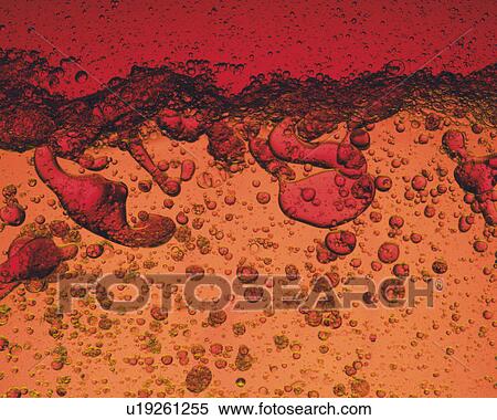 Red and Orange-colored Oil Being Poured, Containing a Lot of Bubbles, High Angle View View Large Photo Image Stock Photography - Red and Orange-colored Oil Being Poured, Containing a Lot of Bubbles, High Angle View. Fotosearch