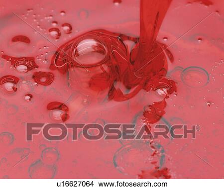Red-colored Oil Being Poured, High Angle View View Large Photo Image Picture - Red-colored Oil Being Poured, High Angle View. Fotosearch