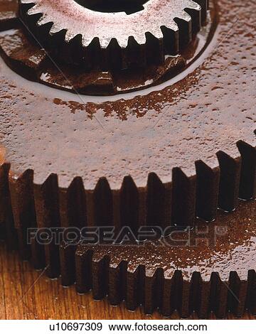 Two Rusty Gears Covered in Oil on a Wooden Ground, High Angle View View Large Photo Image Stock Photo - Two Rusty Gears Covered in Oil on a Wooden Ground, High Angle View. Fotosearch
