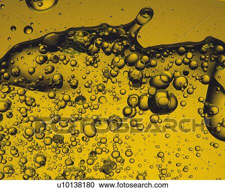 Stock Image - Yellow Oil, Containing a Lot of Bubbles, Front View. Fotosearch