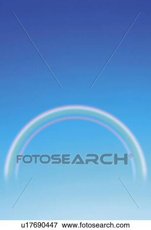 Stock Photo -  a Rainbow in the Middle of the Blue Sky, Front View, CG, Copy Space. Fotosearch