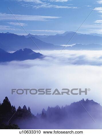 Stock Image -  a Sea of Clouds and Some Mountains Among It, High Angle View. Fotosearch