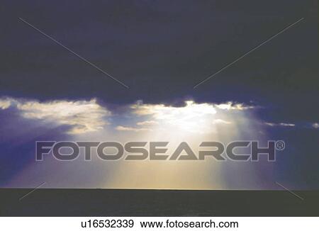 Stock Photo -  a Sea of Clouds, Sunbeams Shining Through, Low Angle View. Fotosearch
