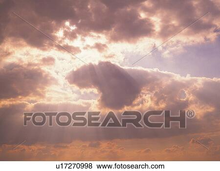 Stock Photo -  a Sea of Clouds, the Sunbeams Shining Through, Low Angle View. Fotosearch