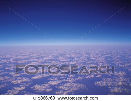 Stock Photo -  a Sea of Clouds, Under a Deep Blue Sky, High Angle View. Fotosearch