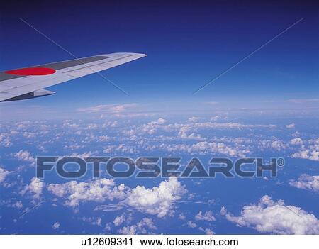 a View From the Airplane, Several Clouds Under a Blue Sky, High Angle View View Large Photo Image Stock Image - a View From the Airplane, Several Clouds Under a Blue Sky, High Angle View. Fotosearch