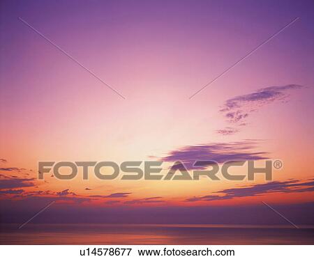 Stock Photo -  an Evening Sky, the Clouds Red From the Sunset, Low Angle View. Fotosearch