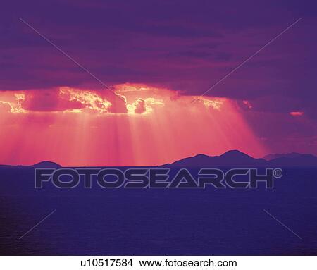 Picture -  Red Sunbeams Shining Through a Sea of Clouds, Low Angle View. Fotosearch