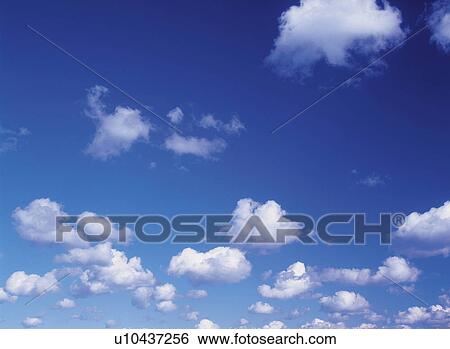 Stock Photograph -  Several Clouds Floating in the Blue Sky, Low Angle View. Fotosearch