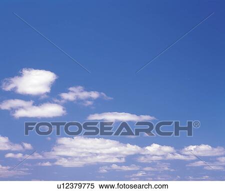 Stock Photography -  Several Clouds Floating in the Blue Sky, Low Angle View, Copy Space. Fotosearch