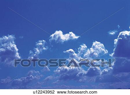 Several Small Clouds Floating in the Blue Sky, Low Angle View View Large Photo Image Stock Image - Several Small Clouds Floating in the Blue Sky, Low Angle View. Fotosearch