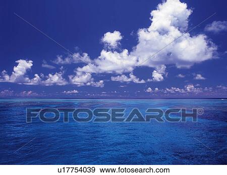 the Ocean Under a Deep Blue Sky With Several Clouds, Front View View Large Photo Image Stock Photo - the Ocean Under a Deep Blue Sky With Several Clouds, Front View. Fotosearch