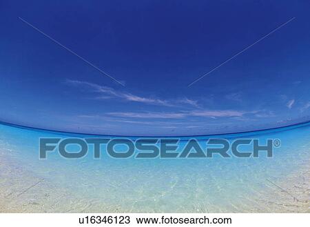 Stock Image -  the Ocean With Light-blue, Clear Water Under a Deep Blue Sky, Fish Eye. Fotosearch