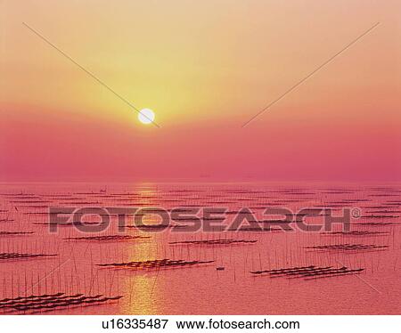 Stock Photo -  the Sea, Reflecting the Colors of the Setting Sun, Front View. Fotosearch