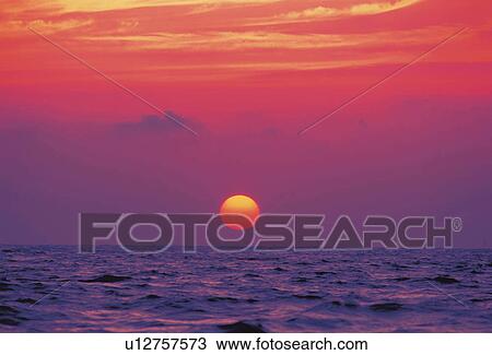 the Sun Going Down at Sea, the Sky Reflecting the Colors of the Sun, Front View View Large Photo Image Stock Image - the Sun Going Down at Sea, the Sky Reflecting the Colors of the Sun, Front View. Fotosearch