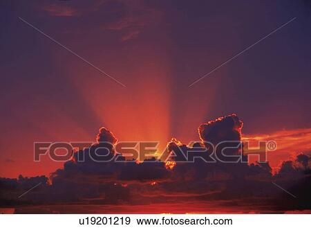 the Sun Going Down Behind Several Clouds, the Sky Red From the Sun, Low Angle View View Large Photo Image Stock Photo - the Sun Going Down Behind Several Clouds, the Sky Red From the Sun, Low Angle View. Fotosearch