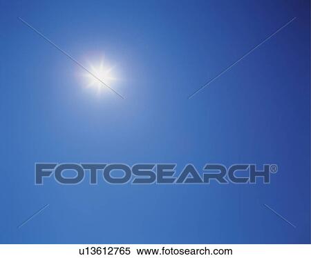 Stock Photography -  the Sun Shining in the Blue Sky, Low Angle View, Lens Flare, Copy Space. Fotosearch