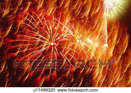 Stock Image - Fireworks exploding in sky, blurred motion, long exposure. Fotosearch