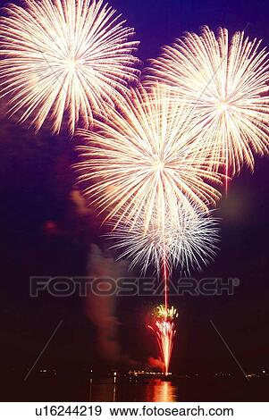Stock Photo - Fireworks exploding in sky, long exposure. Fotosearch