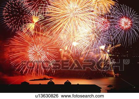 Stock Photograph - Fireworks exploding in sky, long exposure. Fotosearch