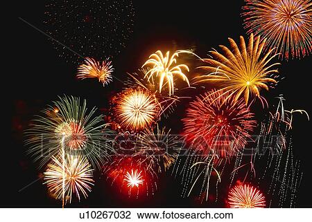Stock Image - Fireworks exploding in sky, low angle view, long exposure. Fotosearch