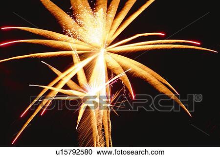 Stock Image - Fireworks exploding in sky, low angle view, long exposure. Fotosearch