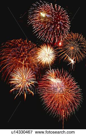 Stock Photo - Fireworks exploding in sky, low angle view, long exposure. Fotosearch