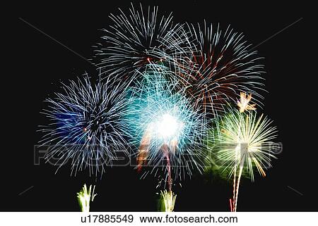 Stock Photo - Fireworks exploding in sky, low angle view, long exposure. Fotosearch