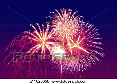Stock Photograph - Fireworks exploding in sky, low angle view, long exposure. Fotosearch