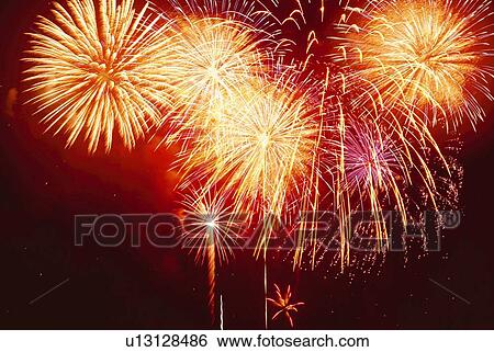 Stock Photograph - Fireworks exploding in sky, low angle view, long exposure. Fotosearch