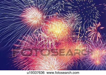 Stock Photograph - Fireworks exploding in sky, low angle view, long exposure. Fotosearch