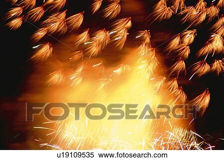 Stock Photography - Fireworks exploding in sky, low angle view, blurred motion, long exposure. Fotosearch