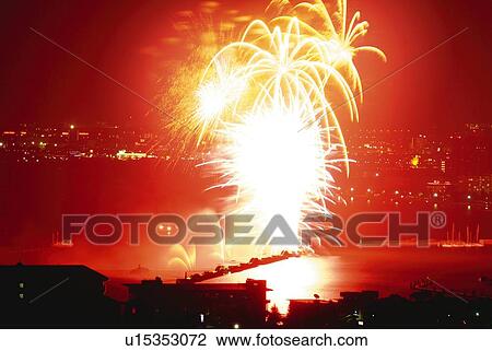 Stock Image - Fireworks exploding on the sea, long exposure. Fotosearch