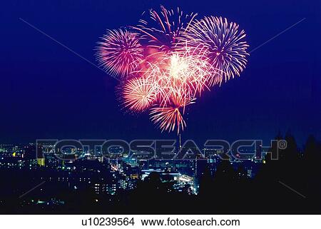 Picture - Fireworks exploding over the city, long exposure. Fotosearch