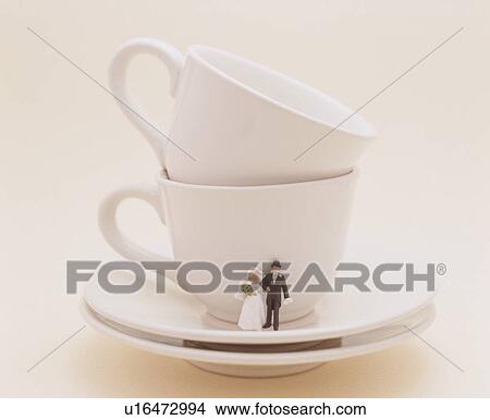 Picture - Bride And Groom On Saucer. Fotosearch