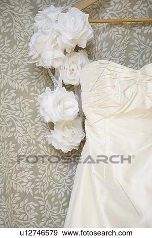 Rose flowers beside wedding dress (close-up) View Large Photo Image Stock Photo - Rose flowers beside wedding dress (close-up). Fotosearch