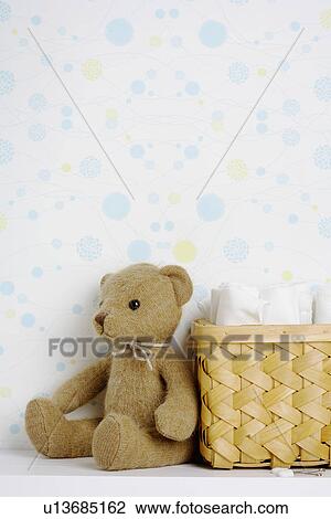 Teddy bear beside basket of diapers View Large Photo Image Stock Image - Teddy bear beside basket of diapers. Fotosearch