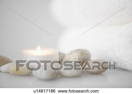 Towels beside candle and stones View Large Photo Image Stock Photograph - Towels beside candle and stones. Fotosearch